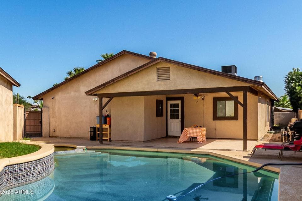 Enjoy your own private backyard oasis featuring a sparkling swimming pool, covered patio, and spacious outdoor living area. This Scottsdale home is perfect for entertaining, relaxing, and making the most of Arizona's beautiful weather.