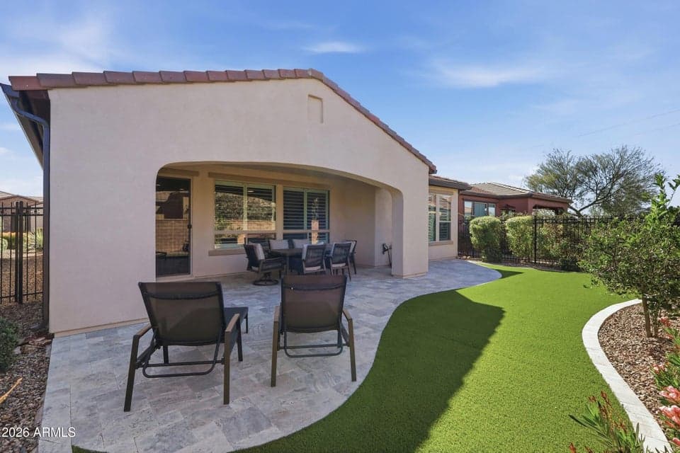 Low-maintenance backyard with covered patio and turf, ideal for lock-and-leave living