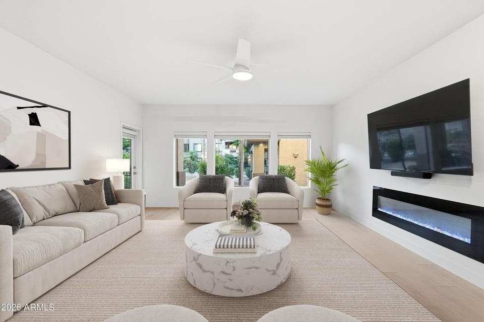 Large living room with natural light, modern linear fireplace, TV and Sonos sound bar.