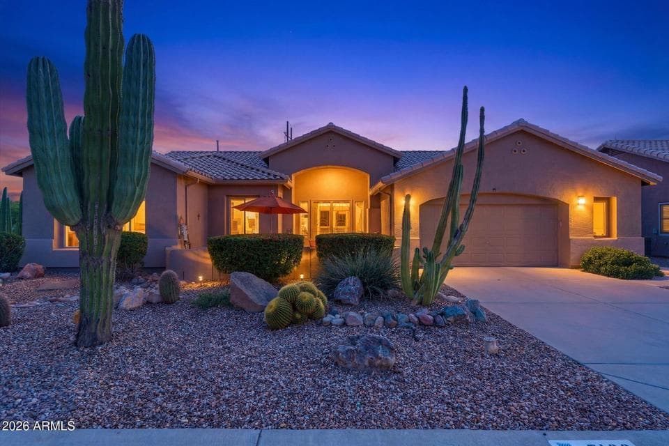 Evening view of the home’s welcoming exterior lighting.