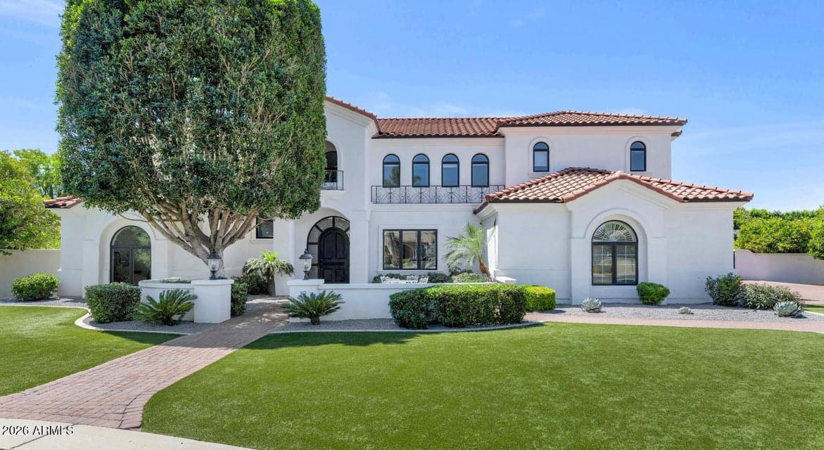 A commanding Mediterranean-inspired elevation sets the tone before you ever step inside. Warm stone detailing, a freshly painted facade, and mature landscaping frame a home that has been loved, invested in, and meticulously maintained. The wide motor court and lush lawn offer an arrival experience that feels both grand and genuinely welcoming.