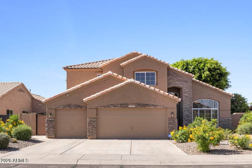 Three-car garage low maintenance landscaping with color