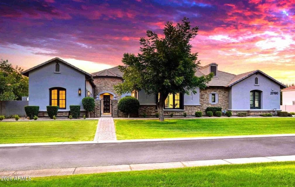 Custom five bedroom home in the Pecans community! The backyard features a custom resort-style lap pool with custom sculptures, water features, pristine travertine decking, and an automatic safety pool cover ideal for families with children. This private luxury retreat is designed for entertaining and recreation, complete with a large fire pit, sport court, custom 9-hole putting green, artificial turf recreation area, and a custom storage shed.
