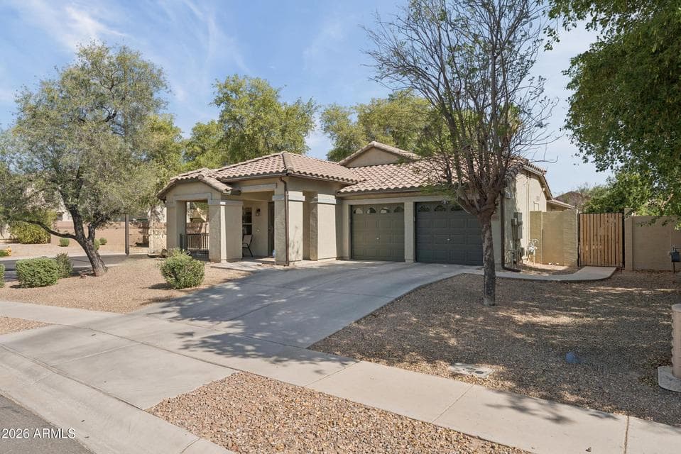 Single level Gilbert home with north/south exposure, mature trees, and refreshed exterior appeal