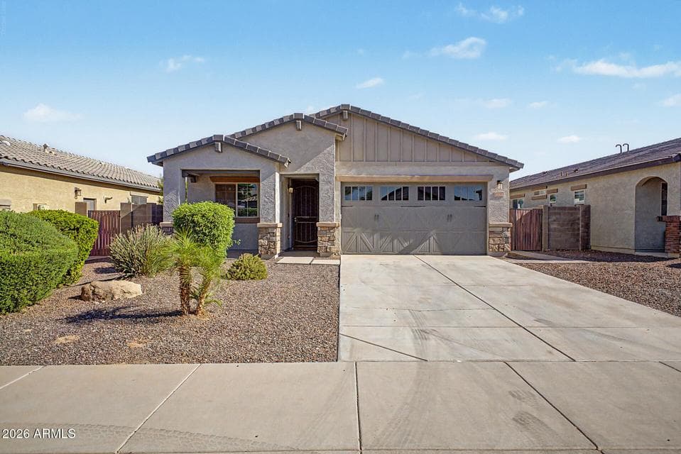 Beautiful curb appeal with attractive desert landscaping and a welcoming front exterior.