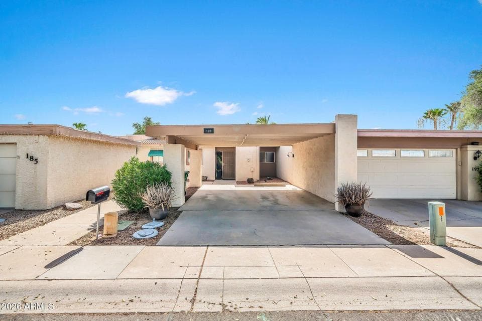 Welcome home to a low-maintenance exterior featuring a covered carport, private front entrance, and clean desert landscaping. This remodeled Litchfield Park property offers convenient lock-and-leave living with timeless architectural appeal and easy access to nearby community amenities.