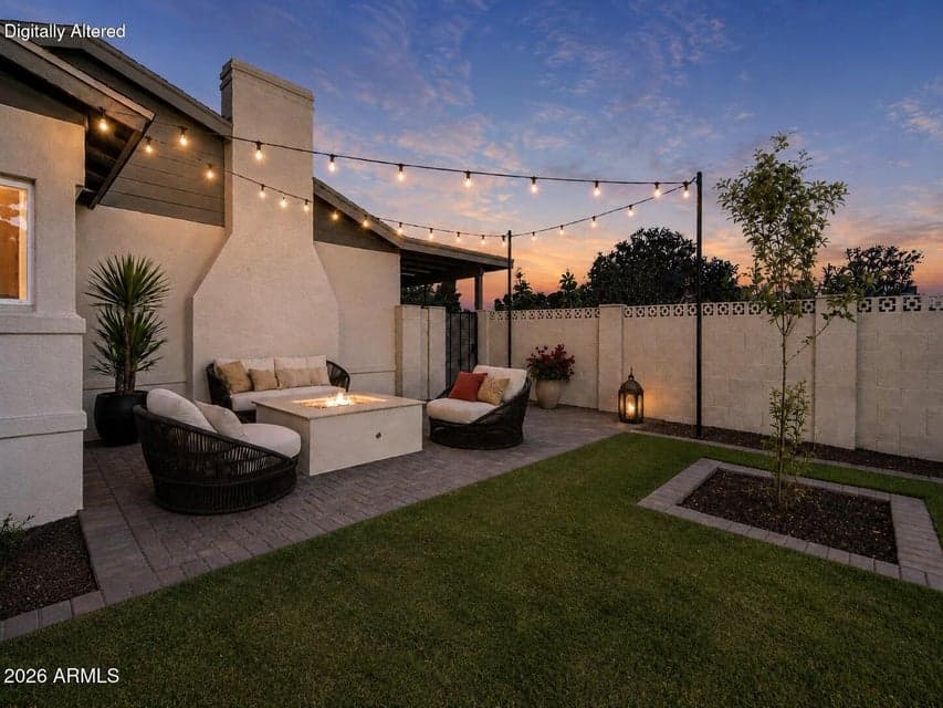 Virtually staged. A broad paver patio, lush turf, and young shade tree create an inviting backyard setting for dining, play, and relaxation.
