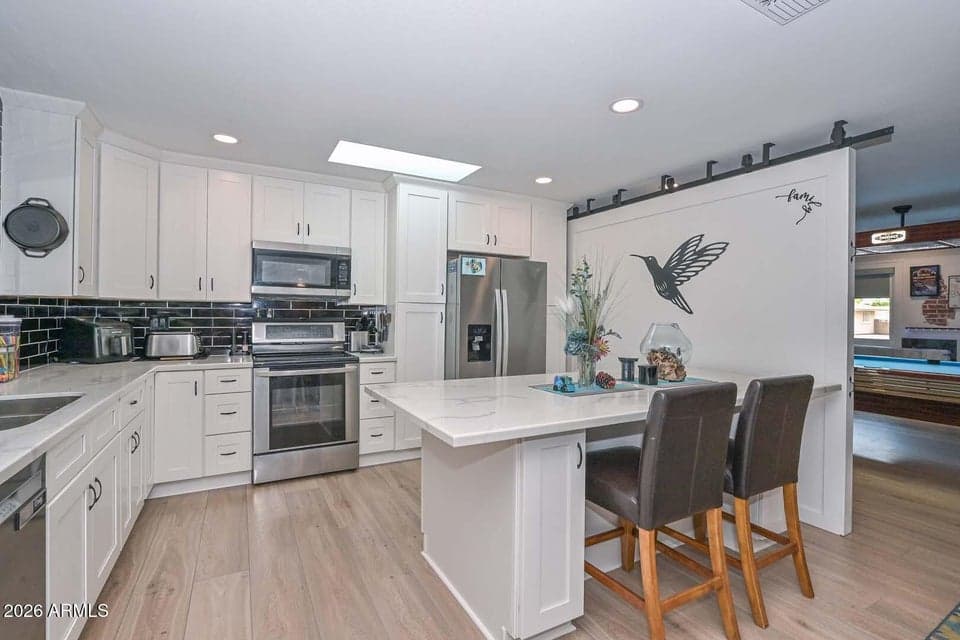 The Barn Door on the right moves back to open up the kitchen to the Living Room