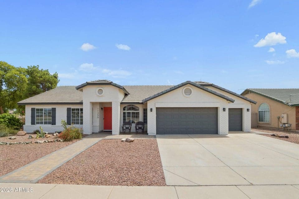 Welcoming single level home with gorgeous front pavers, cheerful front door and an extra large corner lot.