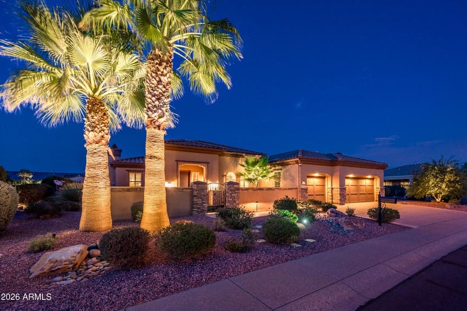Magnificent curb appeal with stone accents, mature palms and upgraded landscape lighting
