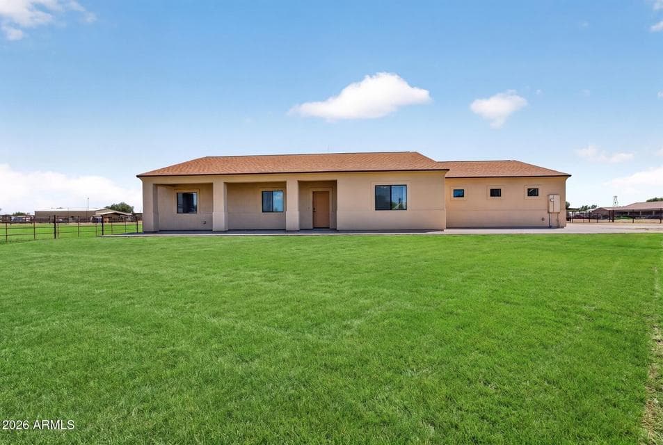Covered patio and grass yard