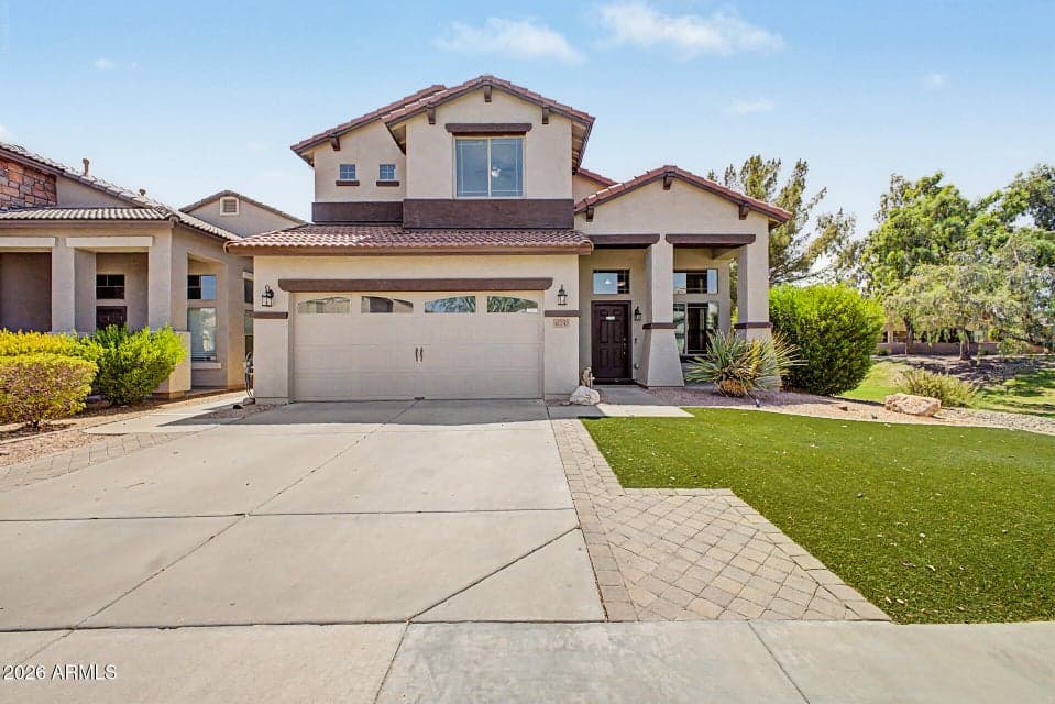 Gorgeouse Curb Appeal in this Surprise, Arizona home featuring a clean exterior, next to park with no neighbor and low-maintenance landscaping.