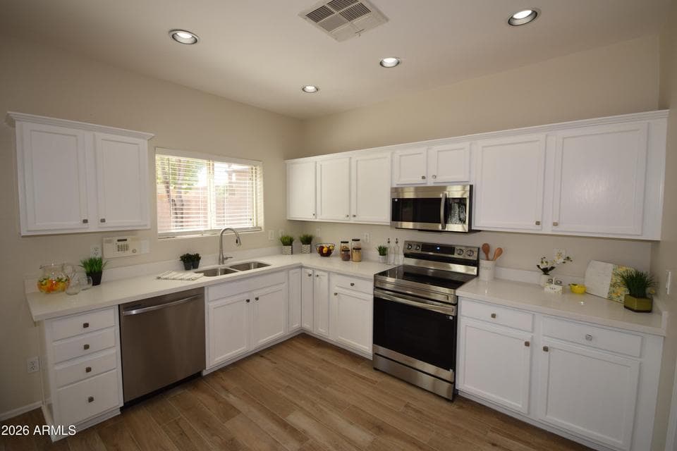 New appliances, new sink/hardware & new painted cabinets.