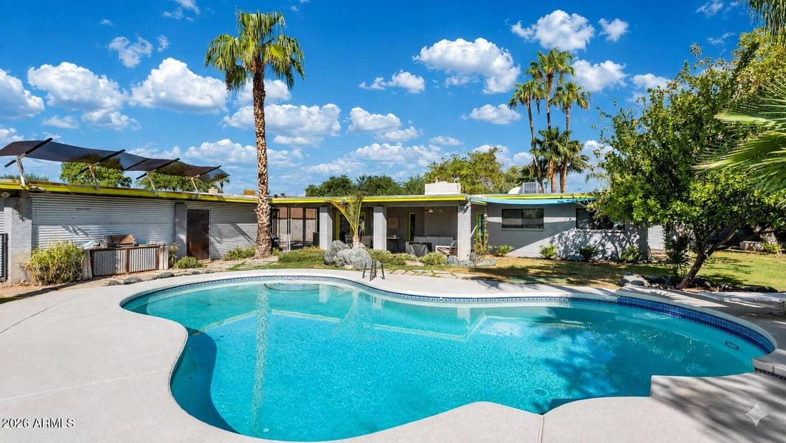 Welcome to 4th street, a modern home with a private backyard oasis, sparkling pool, lush tropical landscaping, and plenty of space to relax under the Arizona sun.