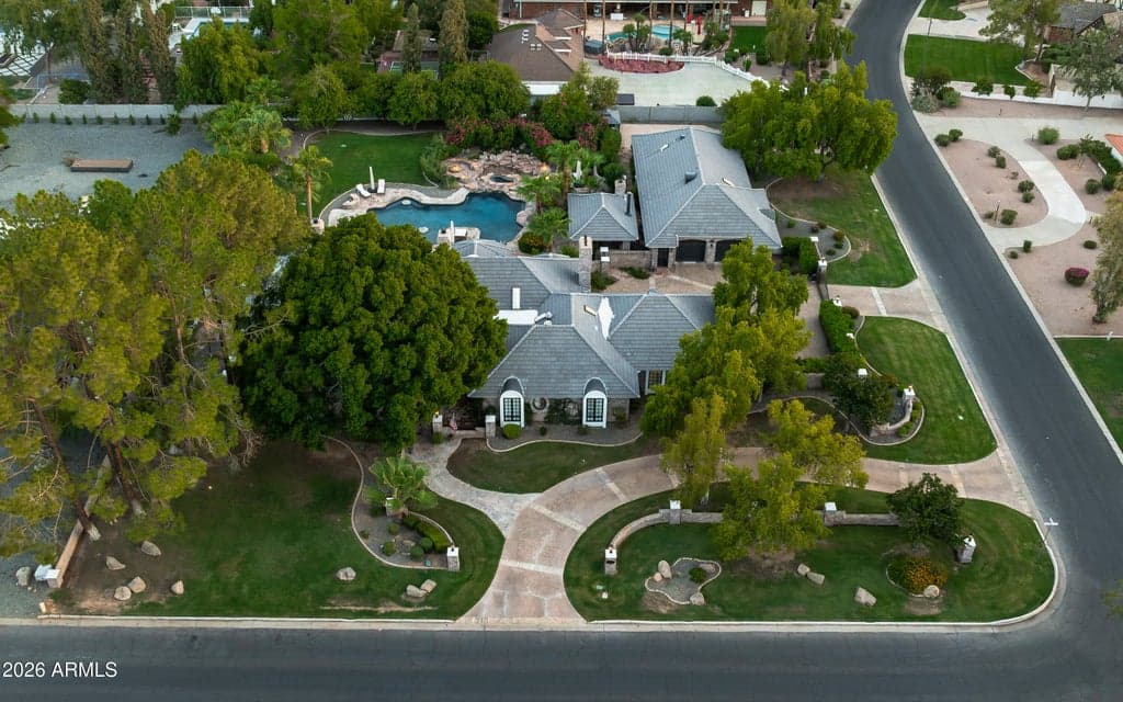 Aerial view showing the residence within its landscaped setting.