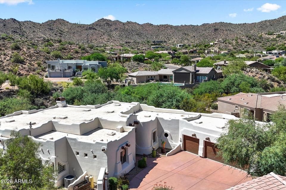 Take in the breathtaking backdrop of rugged mountain views and rolling desert landscape from an elevated perspective, highlighting the property's serene and private setting.