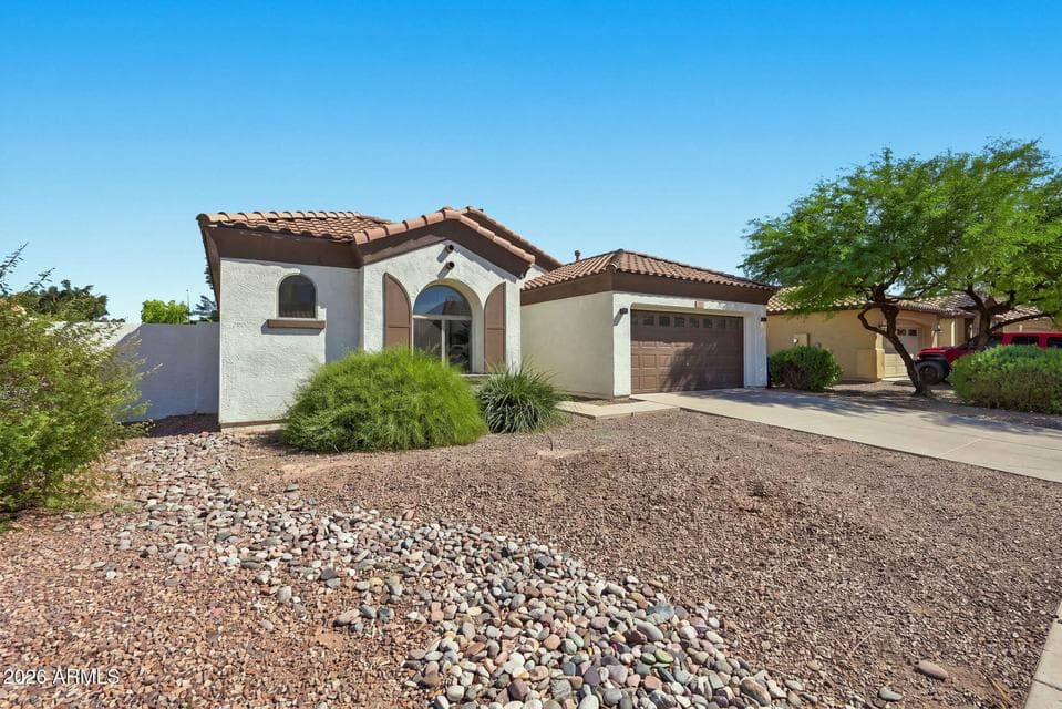 Stucco exterior with fresh neutral paint palette. Low maintenance desert landscaping.
