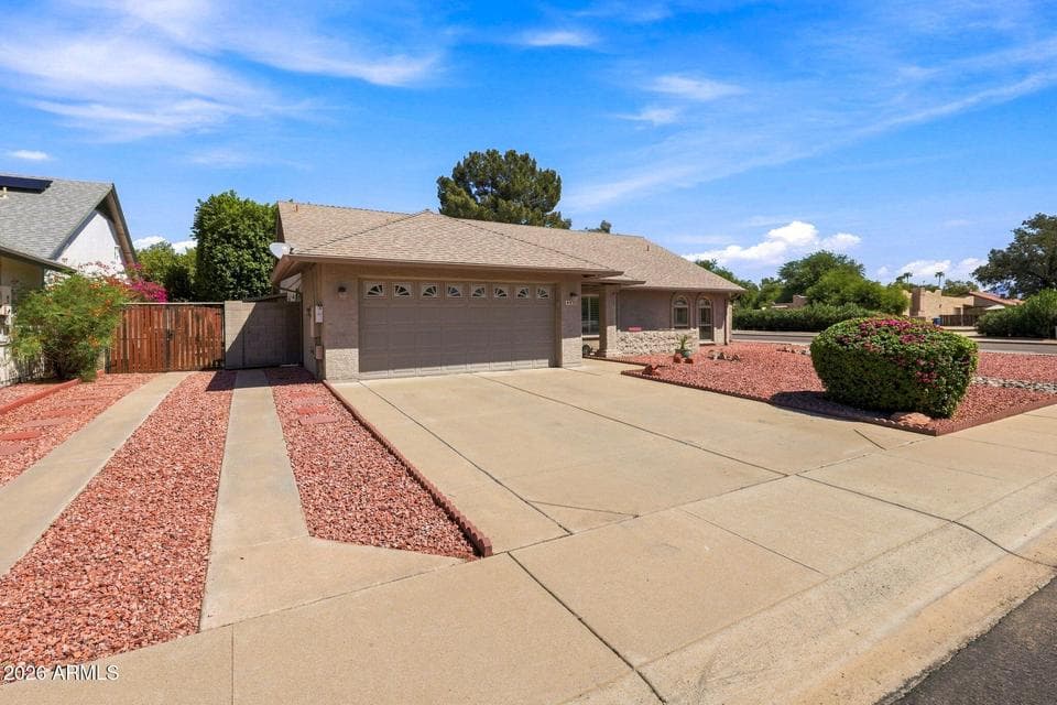 Generous outdoor space with side vehicle access, mature desert landscaping, and zero HOA dues near Desert Ridge & Paradise Valley.