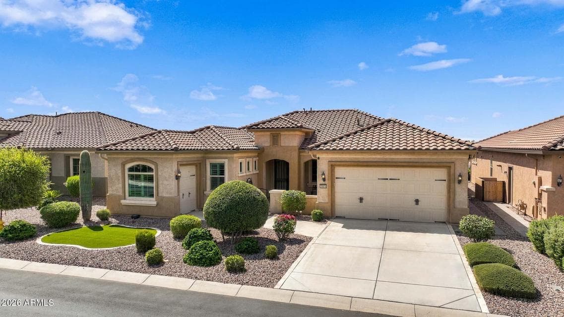 Double garage with additional golf cart garage and private courtyard entrance.