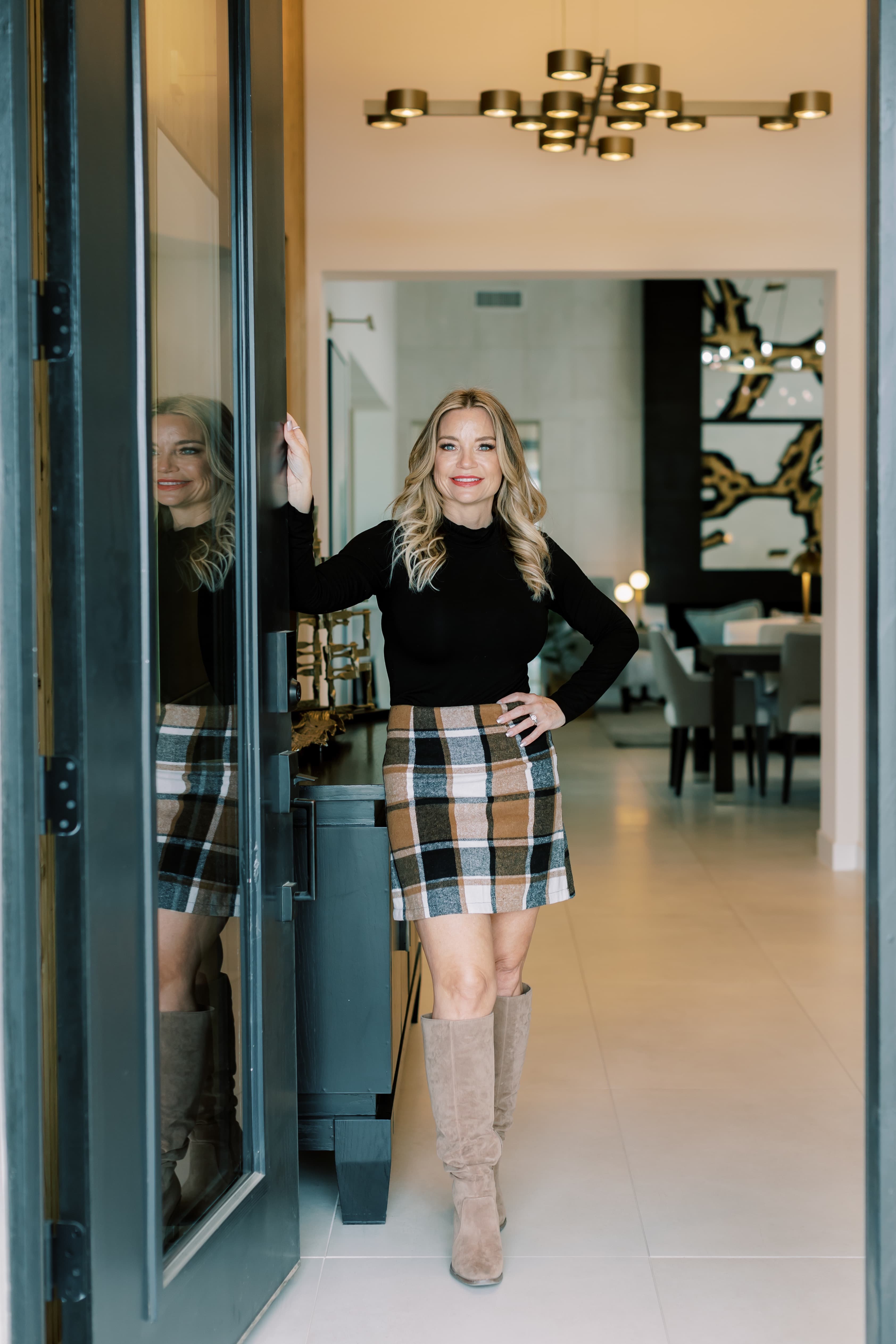 Wendy Macica standing in the entryway of a modern Southeast Valley home