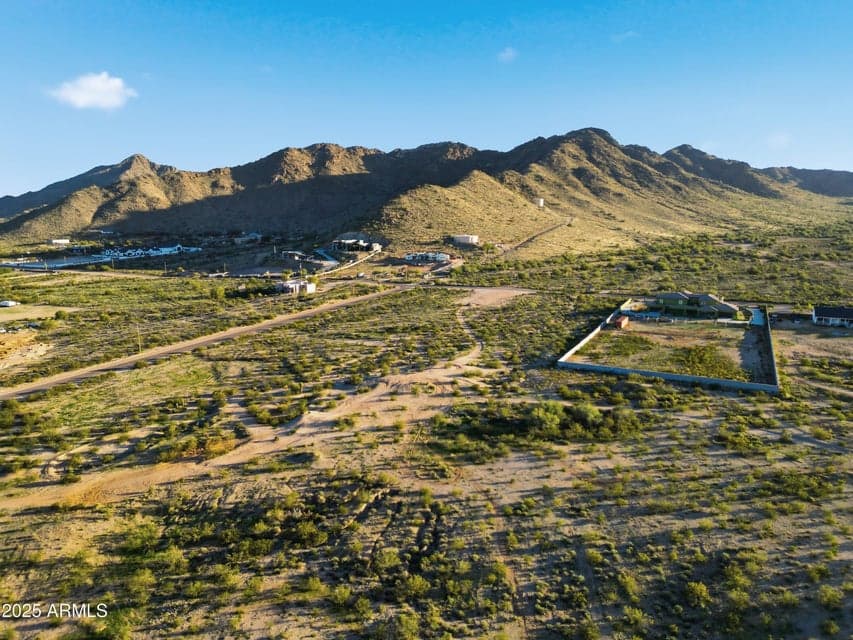 South View. The property begins NE of the corner of the wall. Exquisite views of the SanTan Mountain Range