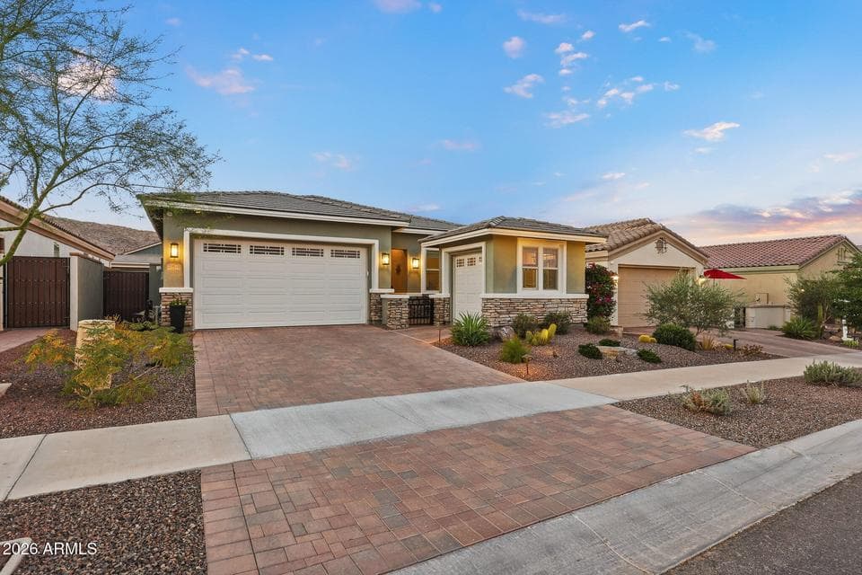 Note golf cart garage, paver driveway + gated courtyard entry
