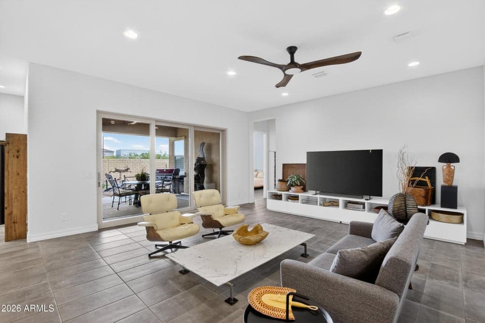 The twelve-foot sliding glass door opens to the patio, creating a smooth indoor-outdoor living experience.