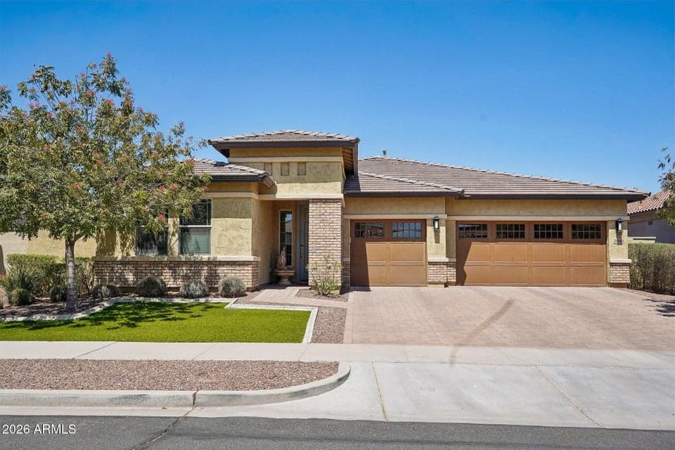 Former model home, 3 car garage, stone paver driveway