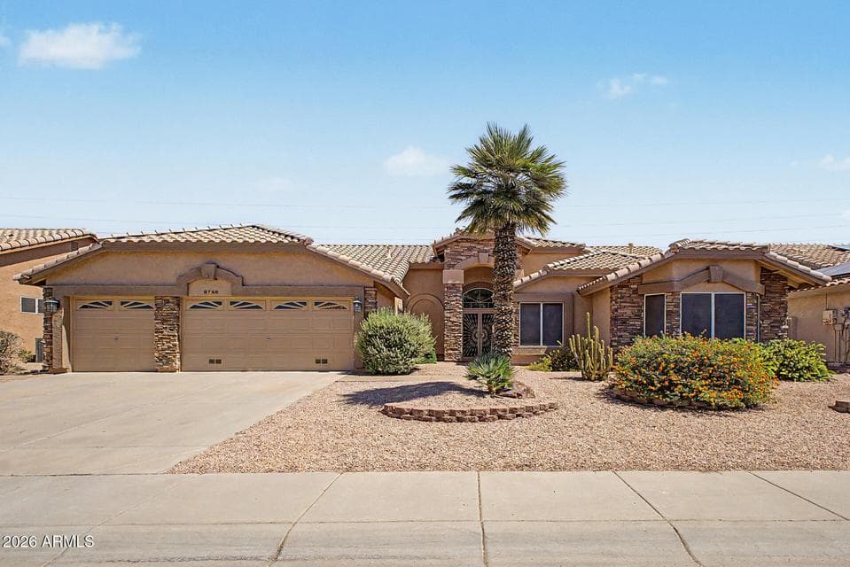 Beautiful curb appeal welcomes you to this Peoria home featuring stone-accented architecture, mature desert landscaping, a spacious three-car garage, and an inviting front entry. The well-maintained exterior and expansive driveway create a stunning first impression while showcasing the home's exceptional pride of ownership.