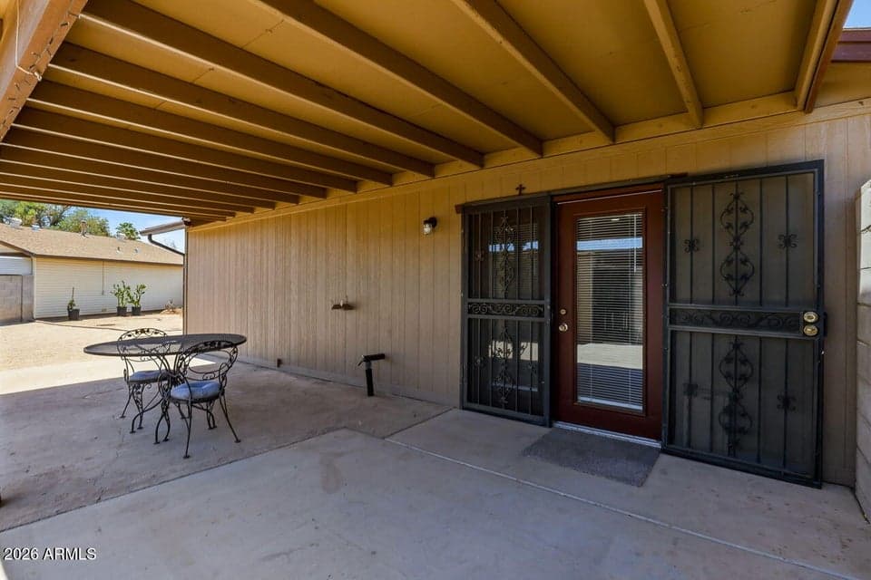 Large covered private patio offering a shaded outdoor living space and quiet backyard retreat.