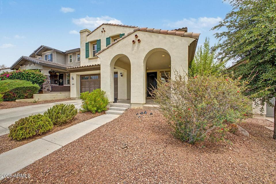 Front of home with easy to maintain desert landscaep
