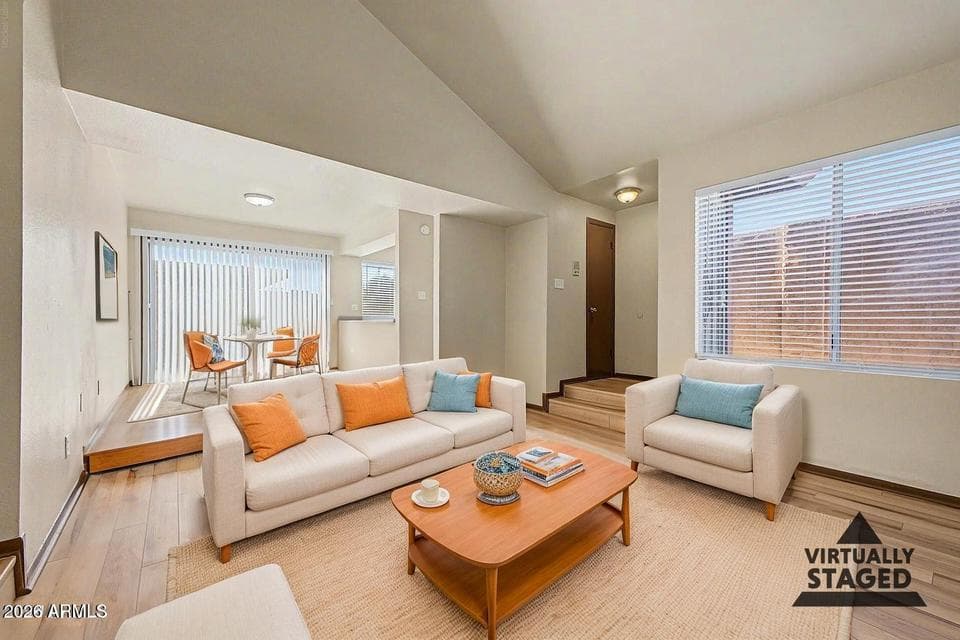Virtually staged to showcase the spacious living and dining areas of this three-bedroom Tempe condo, featuring brand-new flooring and brand-new interior paint.