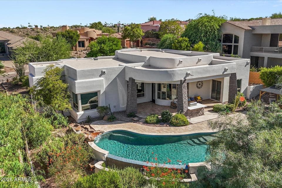 A stunning elevated perspective highlighting the home and its breathtaking mountain backdrop.