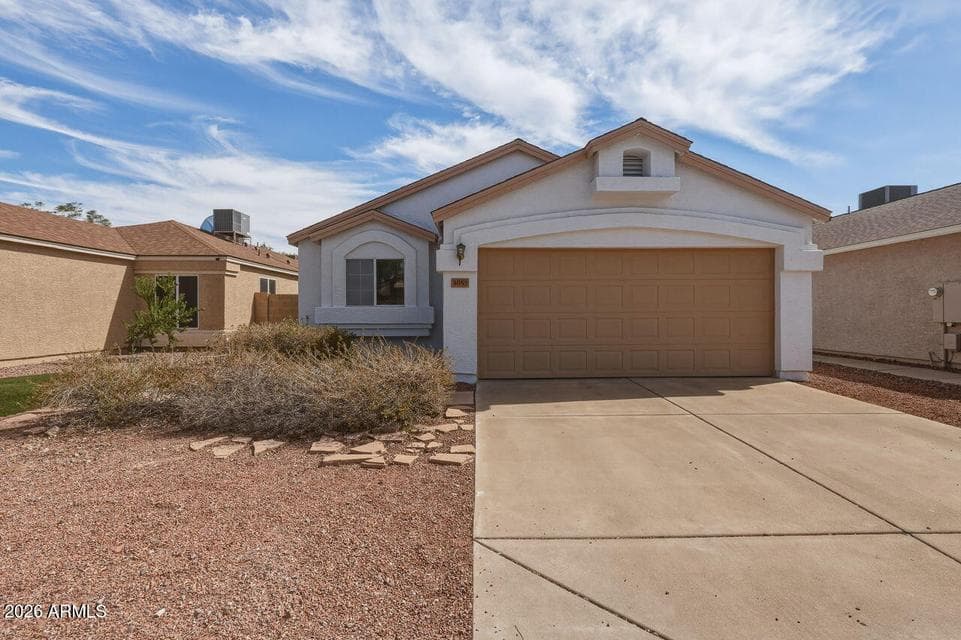 Straight-on view highlights the home’s two-car garage, covered entry and easy-care front yard. A practical single-level design in an established neighborhood.