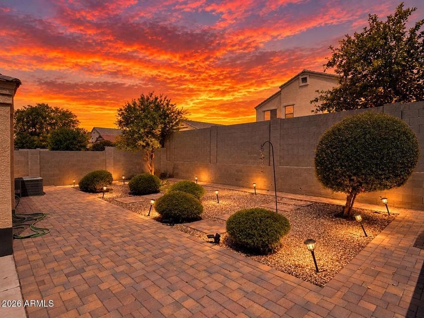 Beautiful custom landscaping with pavers decorative rock, and plants