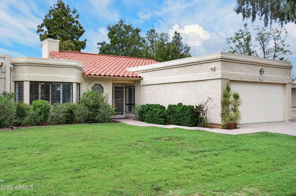 Single level Scottsdale home with lush Lawn, mature landscaping and two car garage
