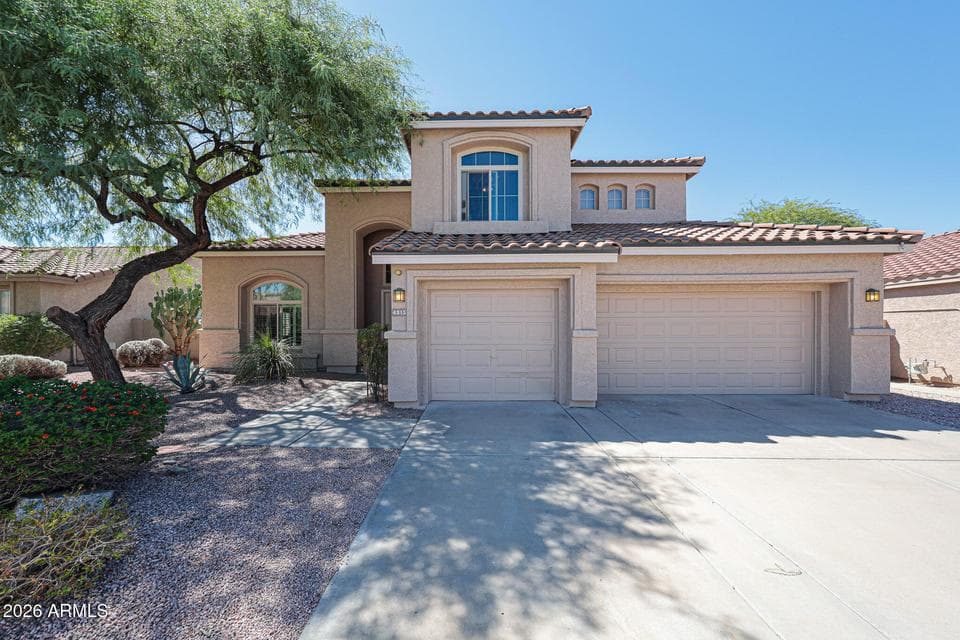 A welcoming exterior, mature landscaping, and a three-car garage set the stage for everything this Desert Ridge home has to offer.