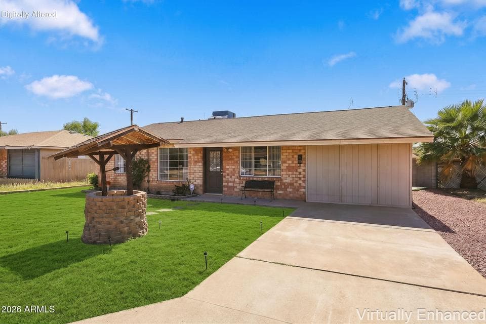 Brick-front single-level home with a charming wishing well out front.