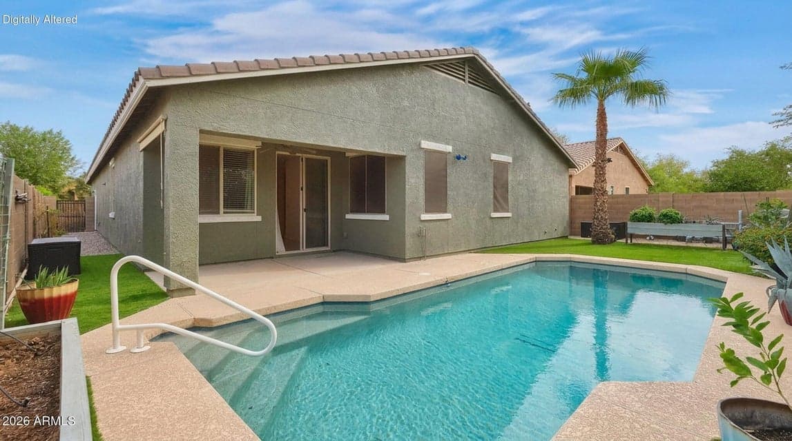 Digitally altered: pool cleaner removed. Private pool with covered patio, artificial grass and mature trees.